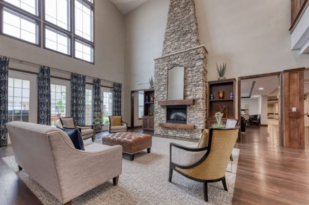 Bright common area with modern furnishings and stone fireplace