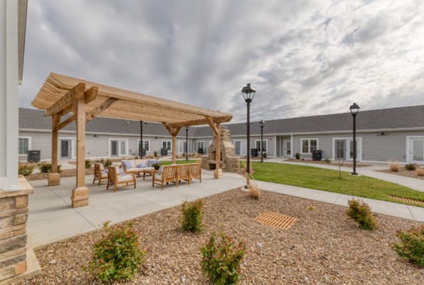 Outdoor seating area with pergola and landscaping