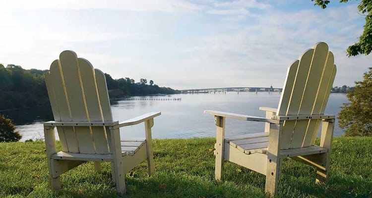Two chairs overlooking a peaceful river view