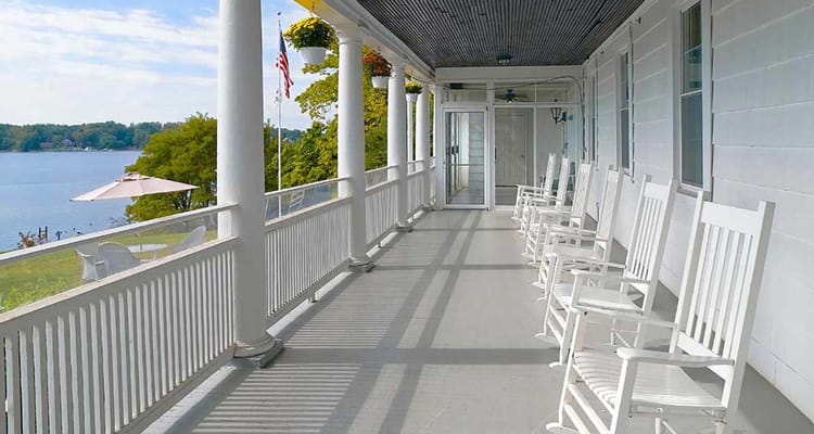 Porch with rocking chairs overlooking a lake