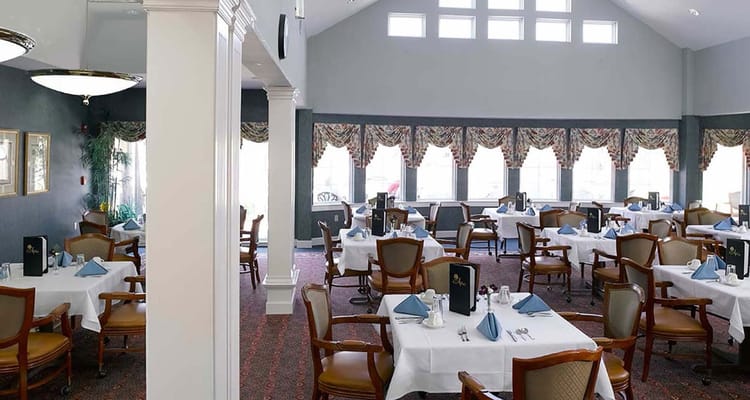 Elegant dining room with neatly set tables and chairs