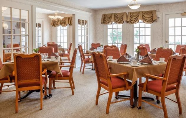 Bright dining room with tables set for meals