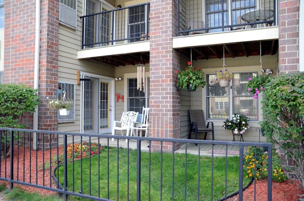 Well-maintained outdoor space with plants and chairs