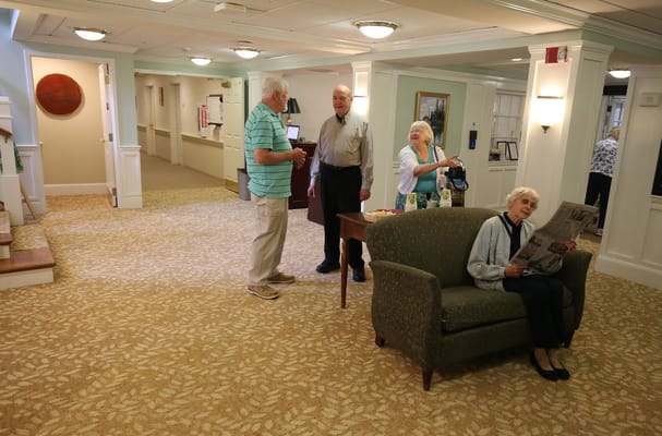 Residents and staff interacting in a common area