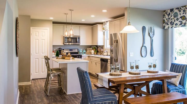 Bright kitchen and dining area with modern appliances and seating.