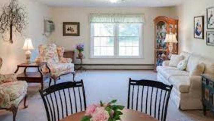 A spacious living room with comfortable seating and natural light.