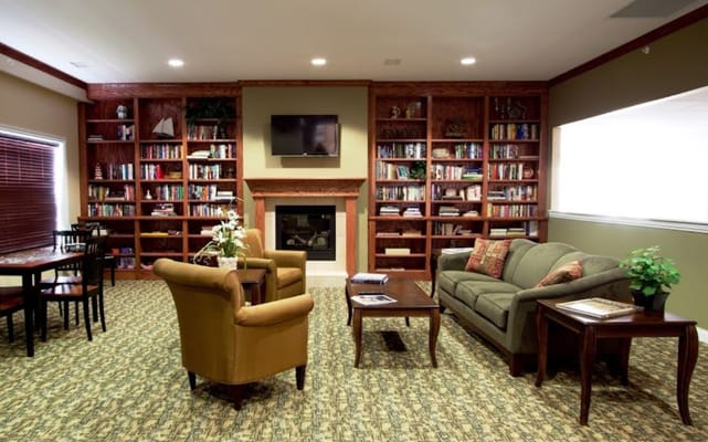 A cozy common area with seating and bookshelves