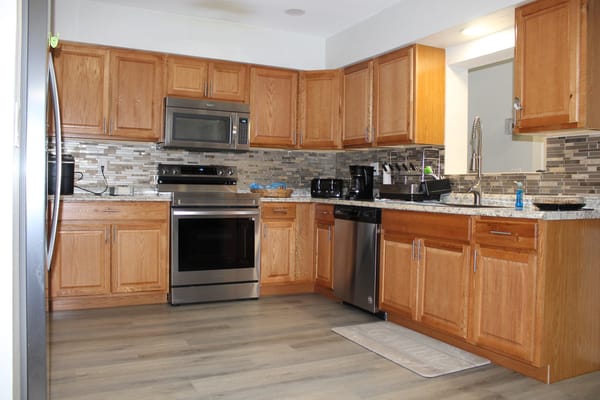 Spacious kitchen with wooden cabinets and modern appliances