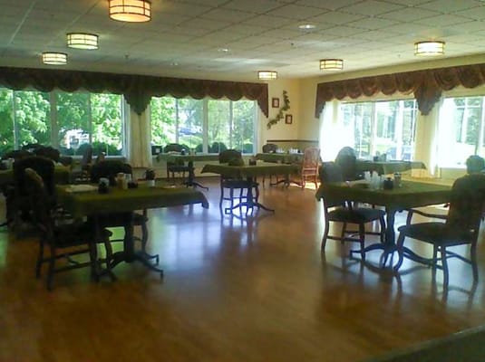 Dining area with tables and chairs near large windows
