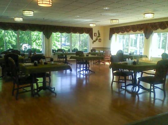 Dining area with tables and chairs in a bright interior