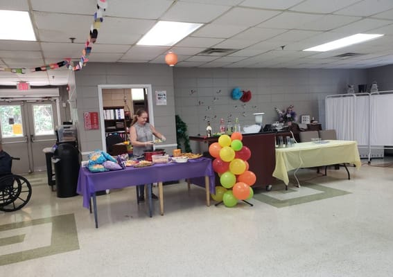 Resident preparing food at a celebration in the common area