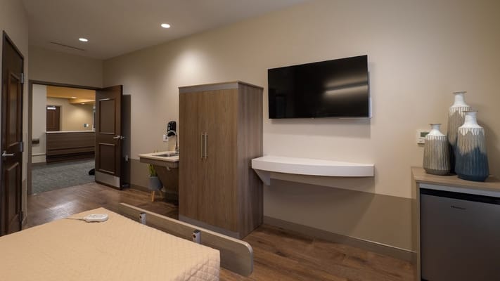 Well-furnished bedroom with a TV and seating area at Cranberry Park.