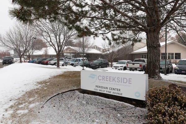 Exterior view of Creekside Transitional Care facility in winter