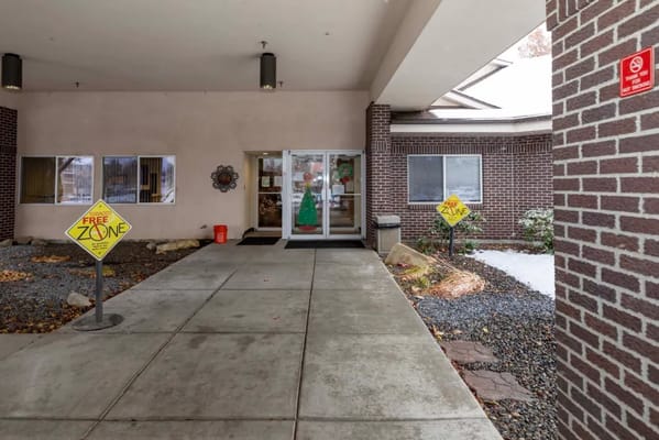Entrance of a senior care facility with signs and decorations