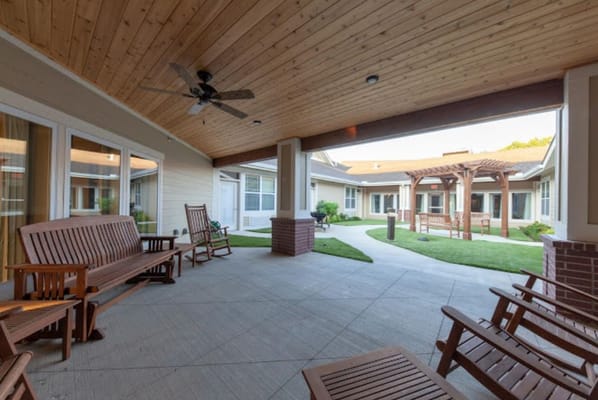 Covered outdoor seating area with wooden benches
