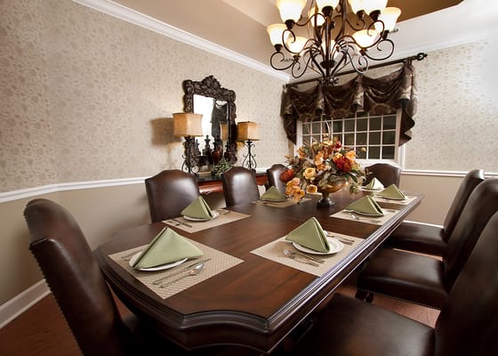 Dining room with a large wooden table set for meals