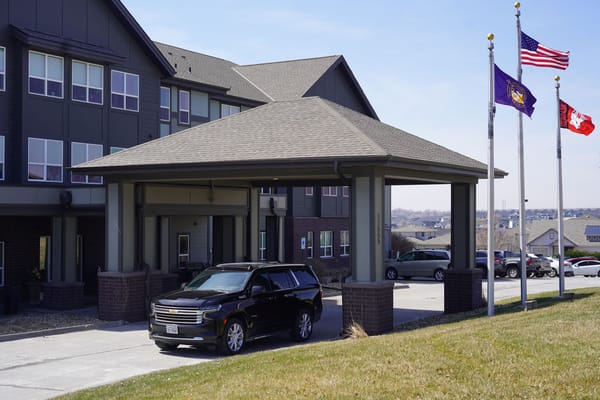 Exterior view of the facility entrance with flagpoles