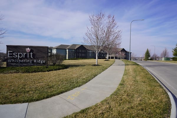 Exterior view of Esprit Whispering Ridge facility with signage