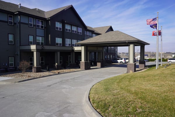 Entrance of Esprit Whispering Ridge with flags