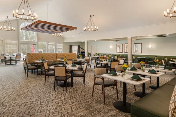 Spacious dining room with tables set for meals