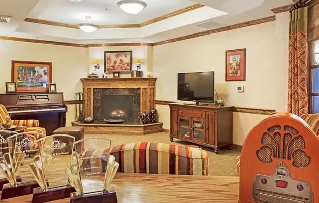 Comfortable living room with seating, fireplace, and television.