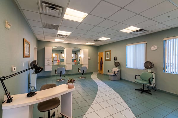 Interior view of a beauty salon with chairs and mirrors
