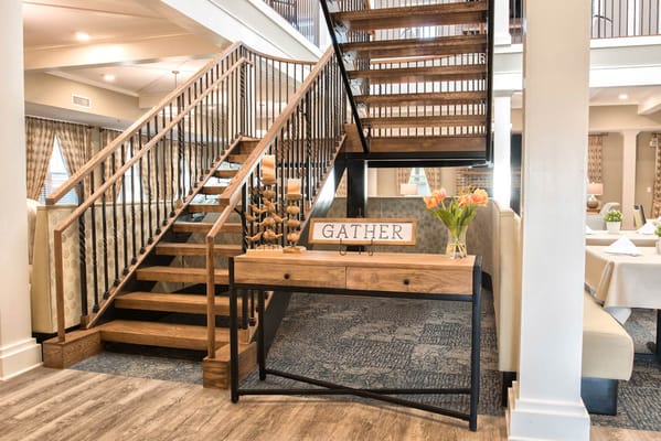 Interior view of a welcoming common area with a staircase