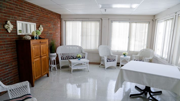 Bright and airy common area with wicker furniture