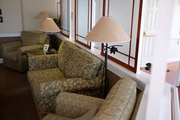 Cozy seating area with patterned sofas and lamps