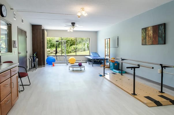 Rehabilitation room with exercise equipment and natural light