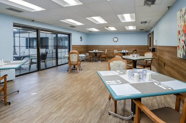 Bright dining area with set tables and chairs