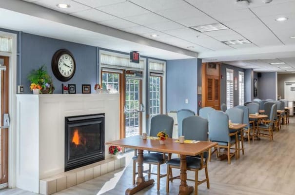 Bright dining area with tables and a fireplace