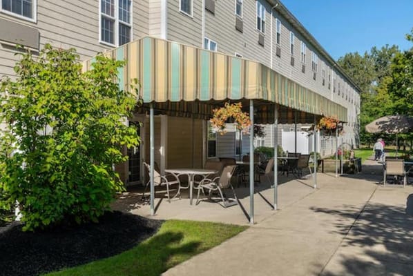 Outdoor seating area with canopy and greenery