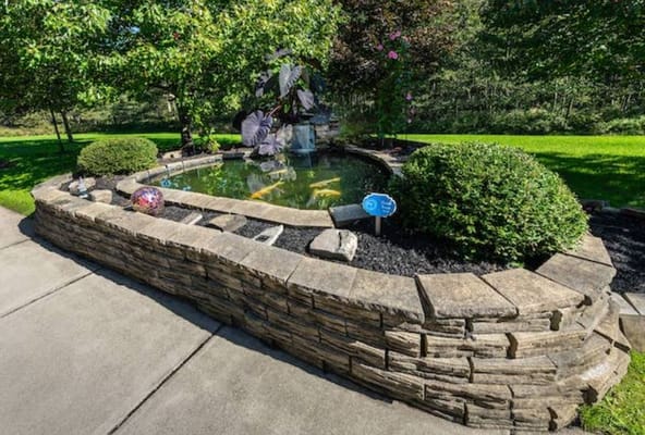 A serene outdoor pond with landscaping features