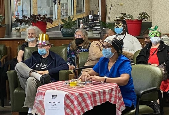 Residents participating in a game activity indoors
