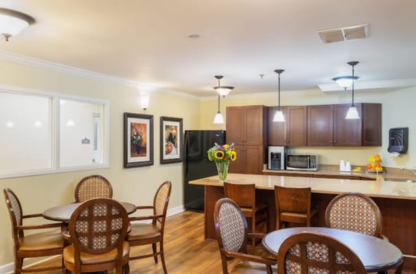 Bright dining area with round tables and flowers