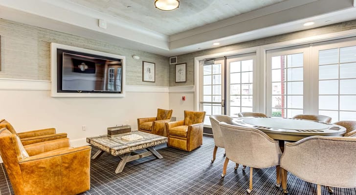 Bright common area with seating and a TV