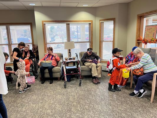 Residents participating in a festive Halloween activity in a common area