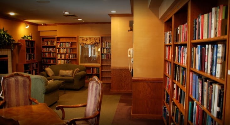 Interior view of a library with bookshelves and seating area.