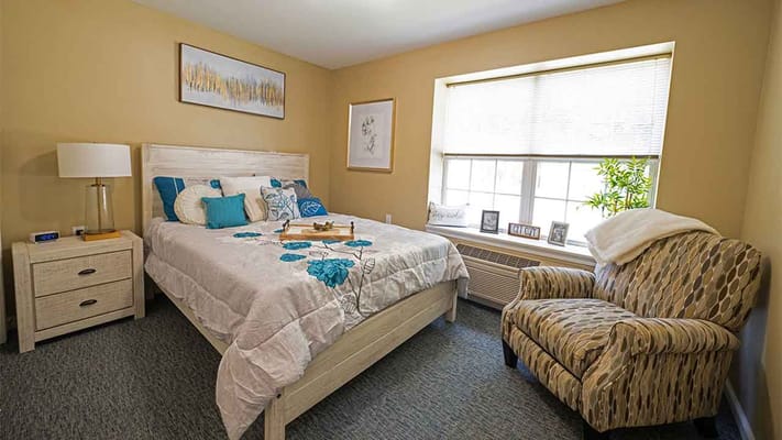 Cozy private resident room with bed and chair