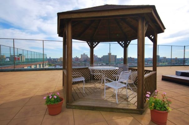 Outdoor gazebo with seating and flowers