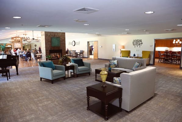 Spacious common area with seating and dining areas in Forest Hills Assisted Living