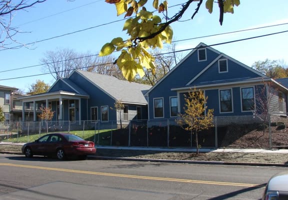 Exterior of Forest View at Fayette, showcasing residential buildings surrounded by a fence.