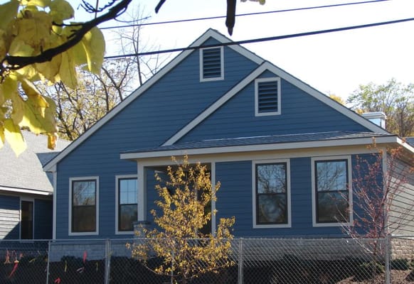 Blue exterior of Forest View at Fayette with surrounding trees.