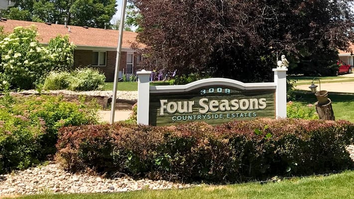 Signage for Four Seasons Apartments with landscaping