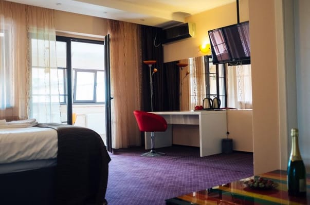 Cozy resident room with desk, chair, and TV