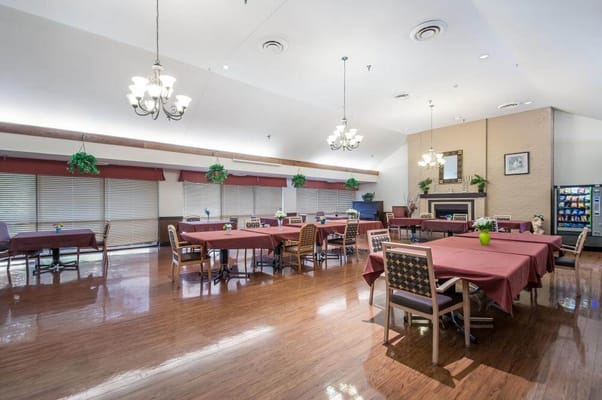 Dining area with tables and chairs set up for residents