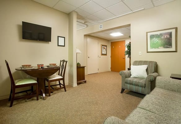 Interior view of a private resident room with dining area