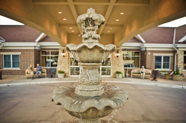 Fountain in front of a senior living facility with residents