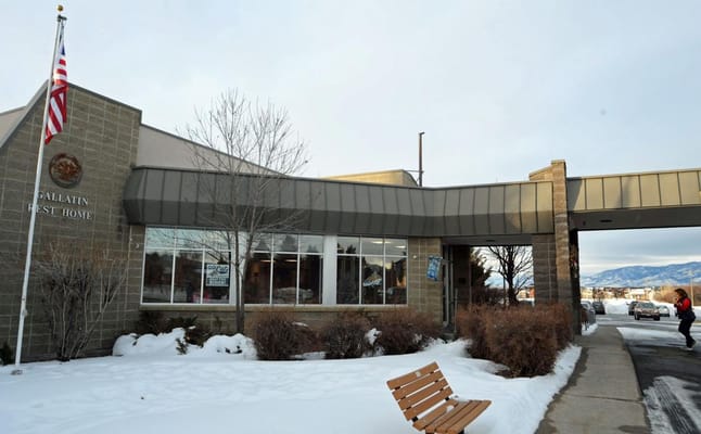 Exterior view of Gallatin Rest Home with snow-covered ground